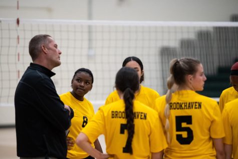 Jason Hopkins (left), Dallas College Brookhaven Campus head women’s volleyball coach, talks with the team during the Lady Bears home match against the Richland Thunderducks on Sept. 29.