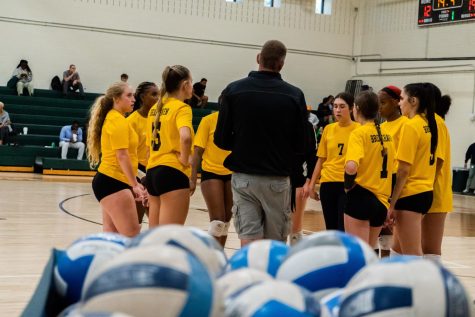 Jason Hopkins (center), Dallas College Brookhaven Campus head women’s volleyball coach, talks with the team during the Lady Bears home match against the Richland Thunderducks on Sept. 29.