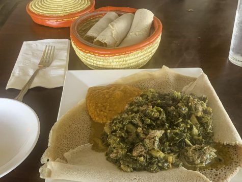 a photo of Injera with gomen besiga (beef and collard greens) and shiro wat (chickpea stew)