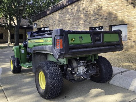 Gator branded with a Punisher logo sits parked outside A Building at Dallas College Brookhaven Campus