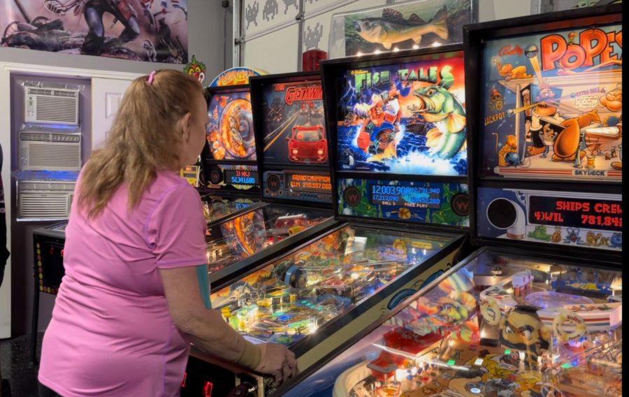Lora Tennison practices on a Fish Tales pinball machine before the start of the tournament.