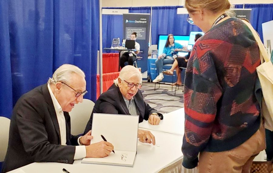 Bob Woodward and Carl Bernstein greet MediaFest22 attendees and write their autographs in books.