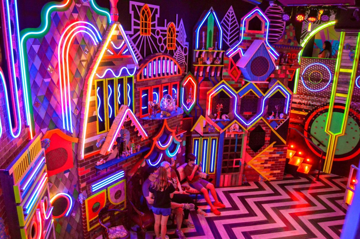 Guests explore the neon decorations at Meow Wolf on Sept. 24.
