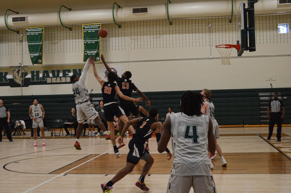 Basketball players jumping for ball.