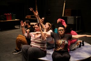 Students in a circle formation posing.