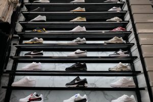 Sneakers displayed on the wall in rows.