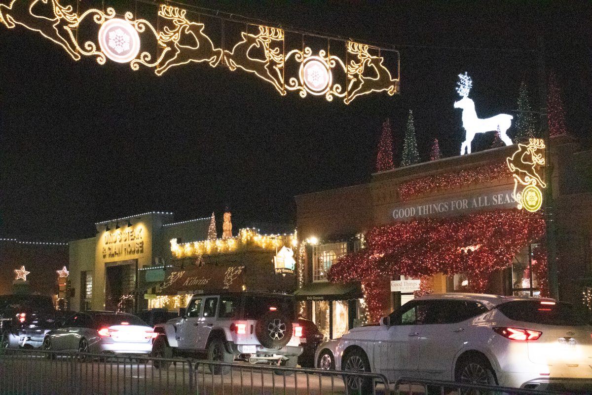 A busy street with Christmas lights.