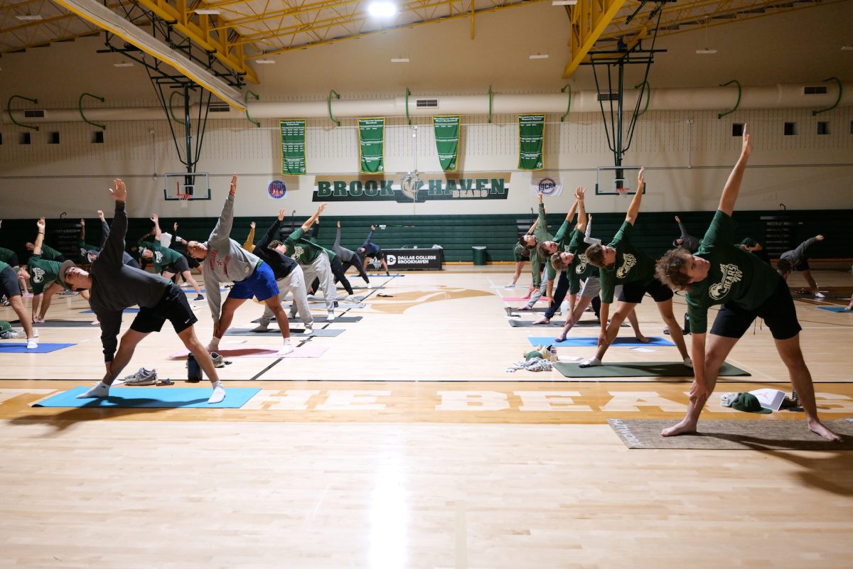 People doing yoga on a mat.