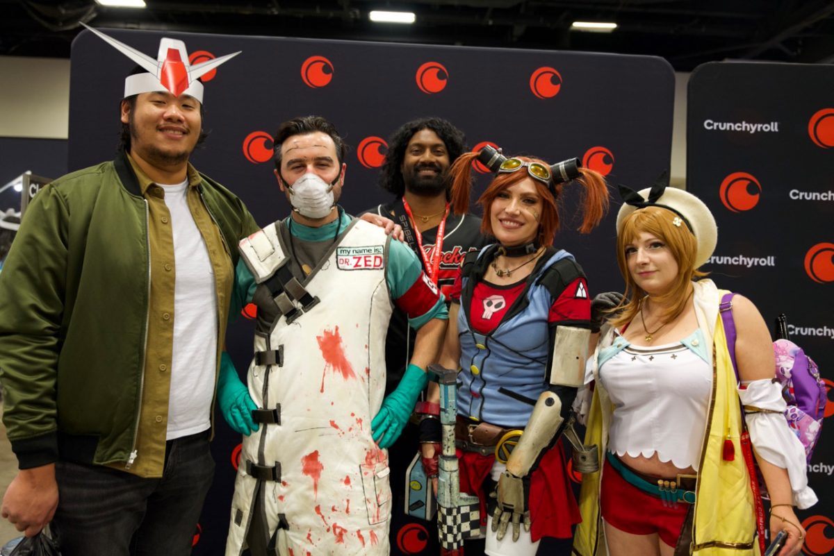 Attendees pose for the camera showcasing their cosplays in the exhibit hall.