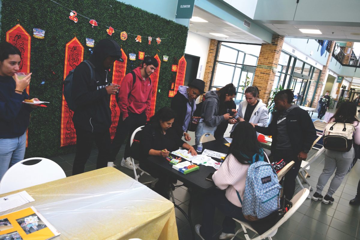 Students gathered around a table with Lunar New Year decorations at the back.