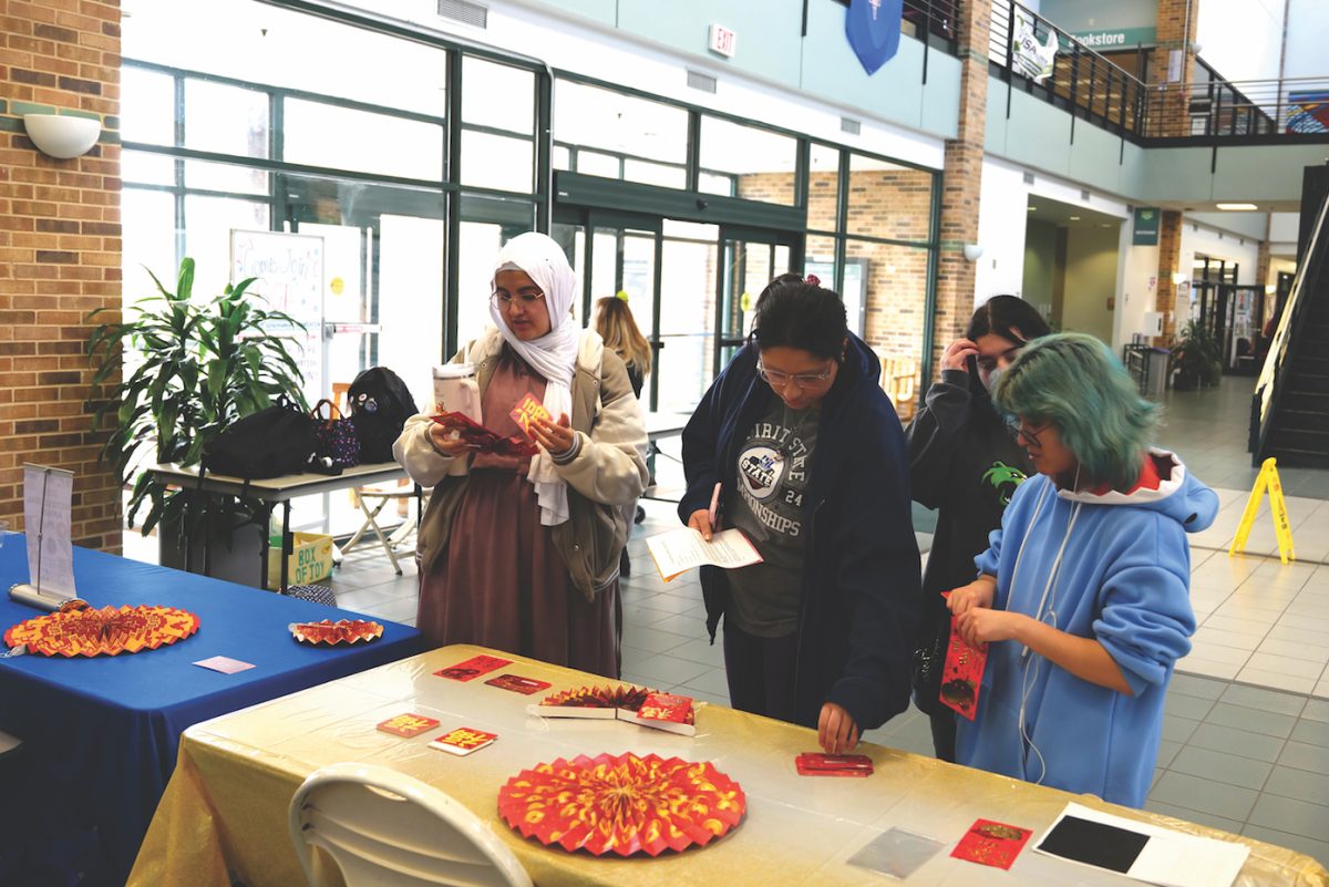 Women grabbing red envelopes.