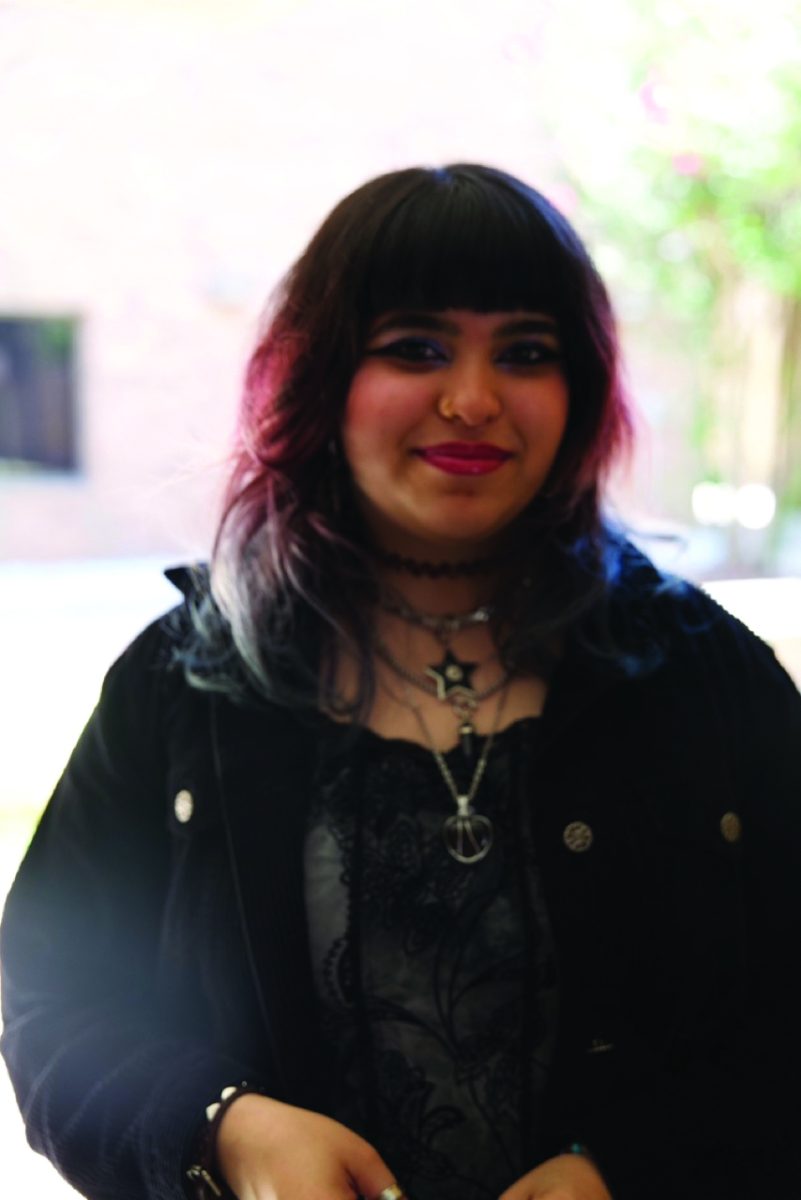 A girl in black jacket standing.
