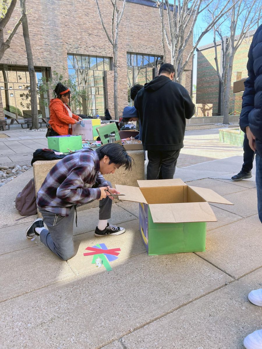 Book member Brandon Mendoza makes a donation box for the book drive.