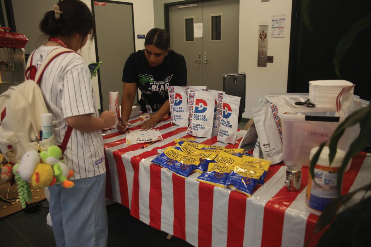 Campus Nurse Mekha marks a student’s bingo sheet which could be completed by doing specific tasks in regards of sex health; students lined around tables to play mini games or to ask questions about sexual health; free STI tests were given via blood draw as well as urine samples.