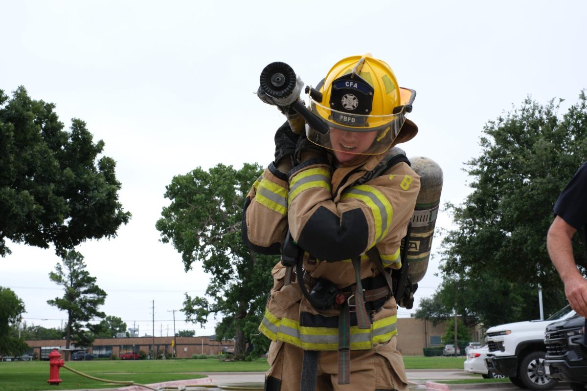 Isaiah Bergeron, 14, drags a fire hose in one of the physical challenges. 