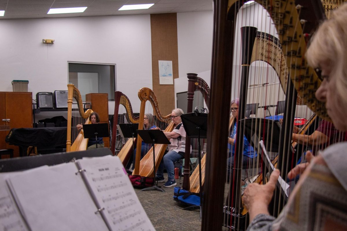 Members of the harp ensemble rehearse "Amazing Grace."