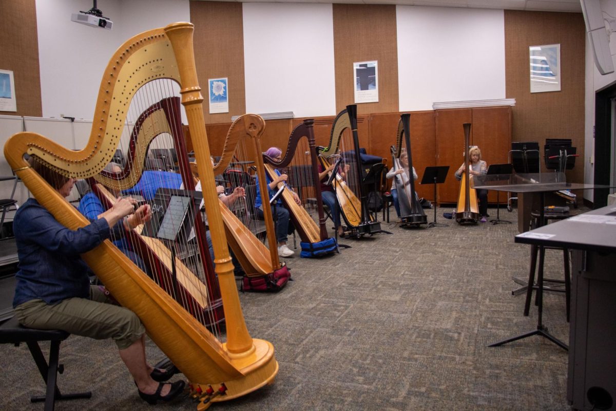 Members of the harp ensemble rehearse "Amazing Grace."