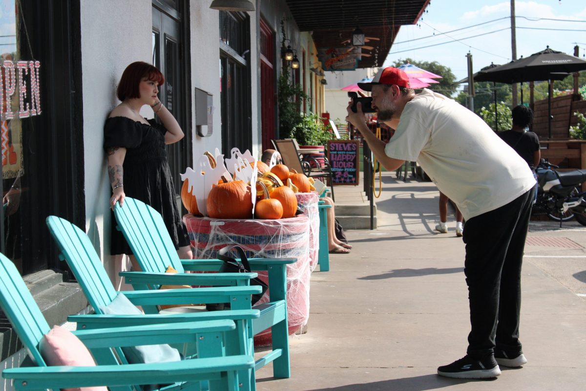 Professor Daniel Rodrigue takes a photo on the Denton Square during Polacon