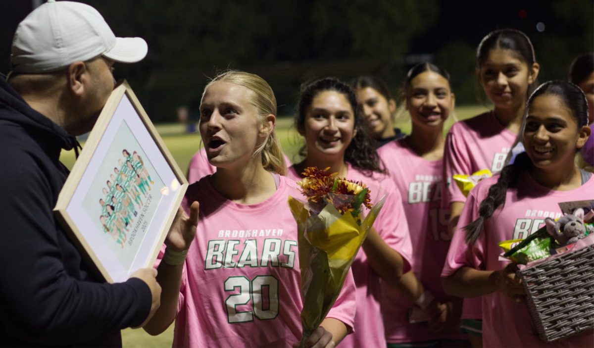 Addison Hanner, No. 20, reacting to a request from Coach Denning to tell a story to the audience.