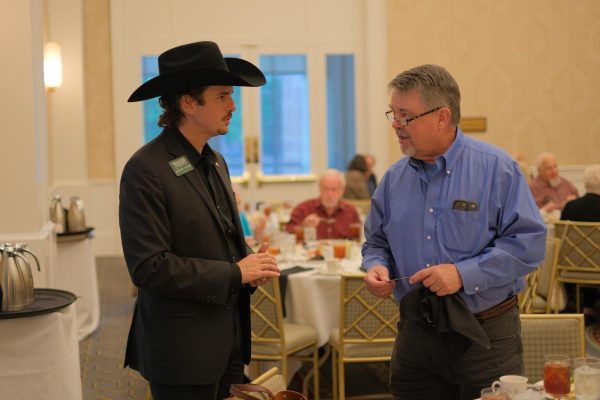 Clayton Tucker speaks with an attendee at the Dallas Democratic Forum luncheon. 